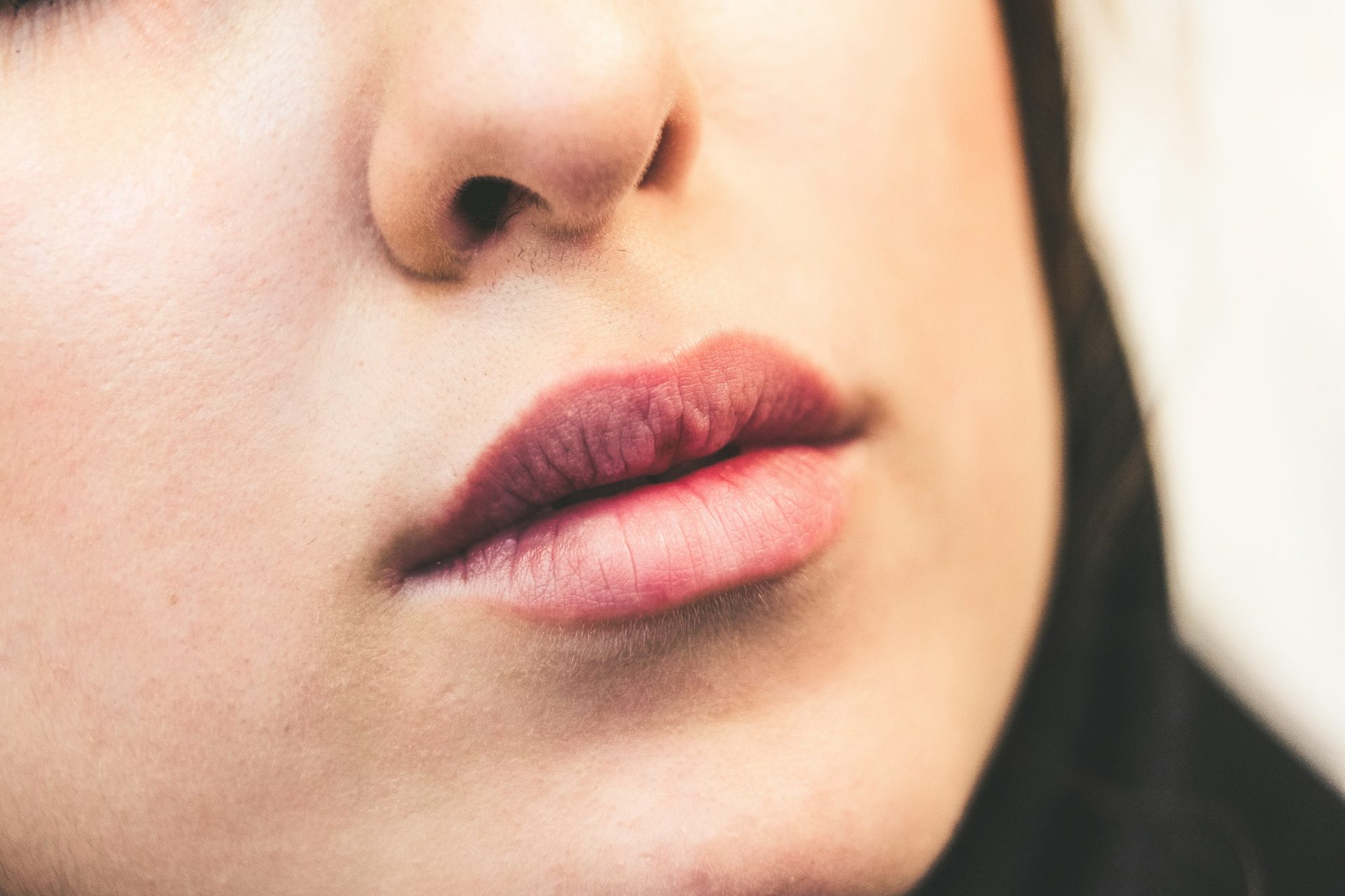 womans face with red lipstick