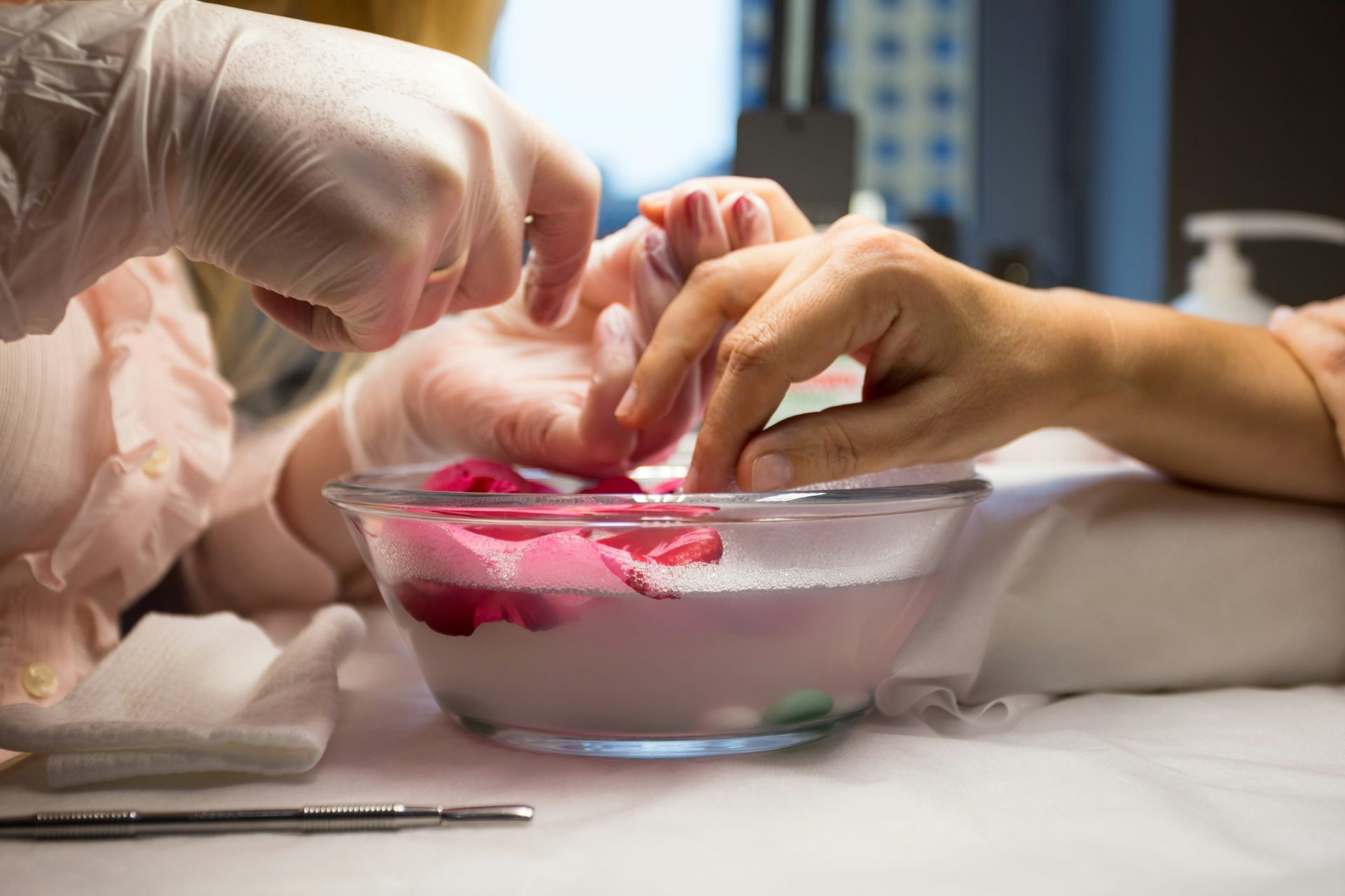 person holding clear glass bowl with red liquid